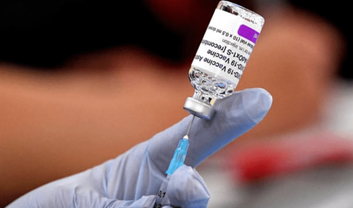 drawing vaccine from astrazeneca bottle with needle