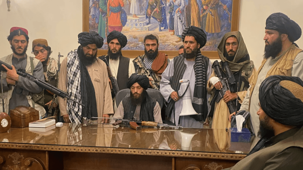 taliban in front of desk in afganistan